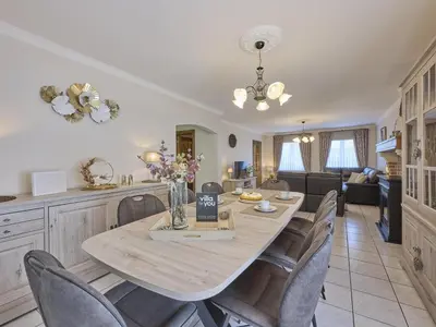 a kitchen and dining room with a table and chairs at Hesbein in Tongeren