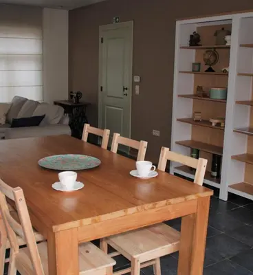 a wooden dining room table with chairs and a tableasteryasteryasteryasteryasteryastery at Vakantiewoning Huys op de Locht in Scherpenberg