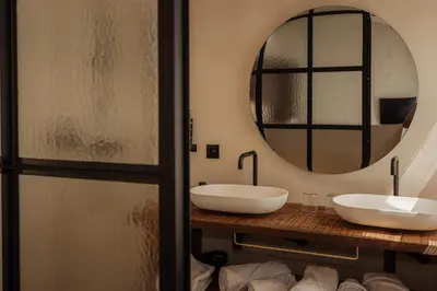 a bathroom with two sinks and a mirror at Guesthouse Just Be Mine in Beringen