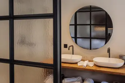 a bathroom with two sinks and a mirror at Guesthouse Just Be Mine in Beringen