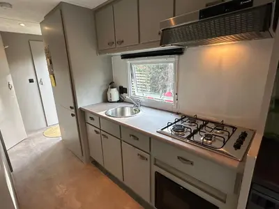 a small kitchen with a sink and a stove at Chalet Tibi in Bocholt