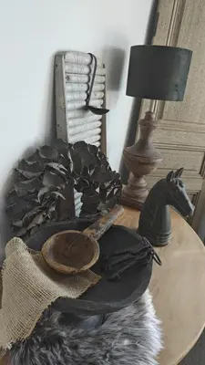 a table with a hat and a horse statue on it at holiday home Zonnestraal in Zonhoven