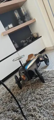 a toy motorcycle sitting on a rug in a room at holiday home Zonnestraal in Zonhoven