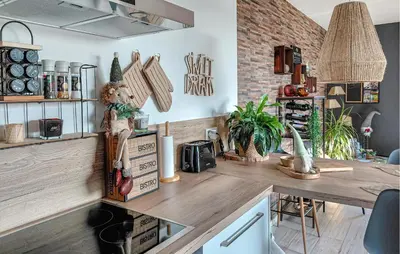 a kitchen with a wooden counter top with a table at 1 Bedroom Lovely Apartment In Visé in Visé