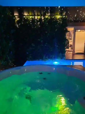 a swimming pool at night with green lights at Clos des Thermes-Zanzibar in Liège