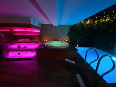 a bathroom with a tub with pink lighting at Clos des Thermes-Zanzibar in Liège