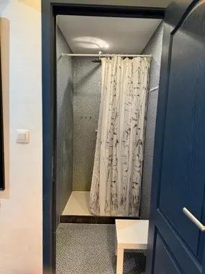 a shower curtain in a room with a door at Le 21 - Appart 3 chambres - centre de Liège in Liège