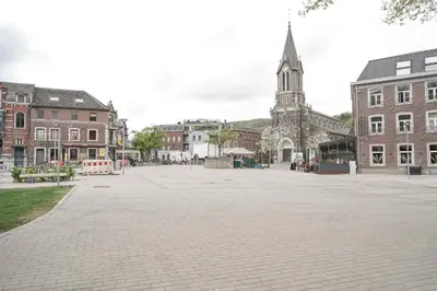 an empty street in a town with a church at Gîte d'artiste, Riverside in Tilff