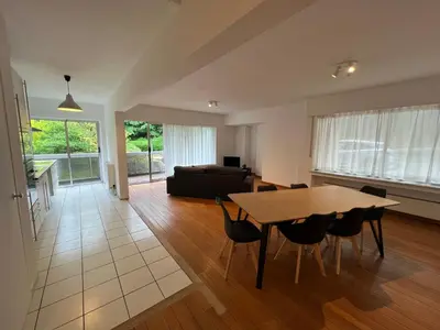 a living room with a table and a couch at Alexis's loft 2 in Liège