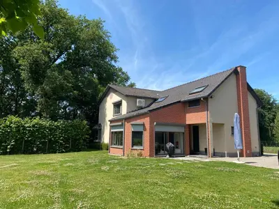 a house with a lawn in front of it at 14 beds, 20p, 2 bath-, 1 livingroom in Houthalen-Helchteren