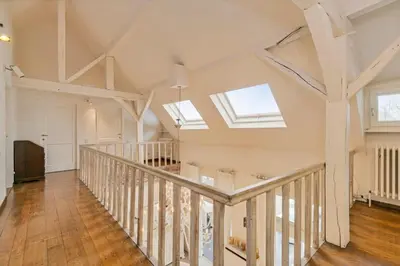 an attic hallway with skylights and wooden floors at Luxe Vacation Villa with swimming pool, 5 bedrooms in Houthalen-Helchteren