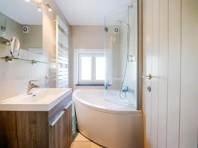 a bathroom with a tub and a sink and a shower at Villa Borgloon with Blossom Views and Jacuzzi in Borgloon