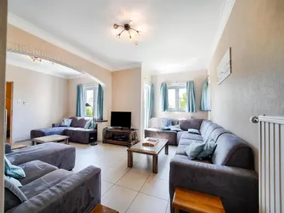 a living room with two couches and a tv at Villa Borgloon with Blossom Views and Jacuzzi in Borgloon