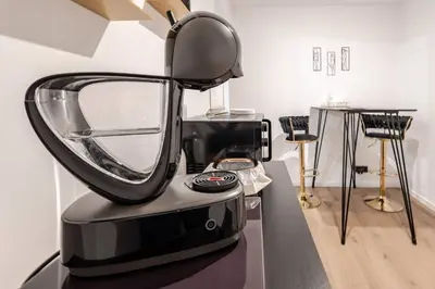 a black blender sitting on top of a table at LoveRoom avec balnéo privative in Flémalle-Grande