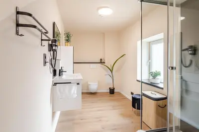a bathroom with a shower and a sink and a toilet at LoveRoom avec balnéo privative in Flémalle-Grande