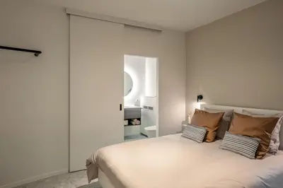 a bedroom with a large white bed with pillows at Borgraaf - Palazzio in Borgloon