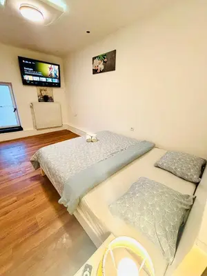 a bedroom with two beds and a flat screen tv at 3 Bedrooms budget appartement in Heers