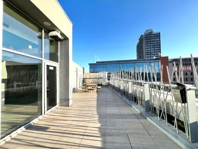 a balcony of a building with a view of a city at Le spot Central securisé sauna rooftop in Liège