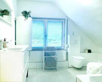 a white bathroom with a sink and a toilet at BEEEP Stay in Hasselt