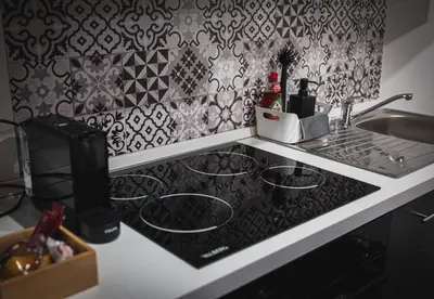 a kitchen counter with a stove and a sink at Loft Ardent in Liège