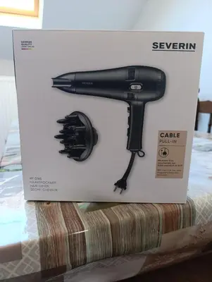 a black hairdryer in a box on a table at résidence KAKIKA in Verviers