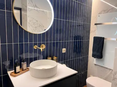 a bathroom with a white sink and a mirror at Garden Street - Antiquity Blue in Lommel