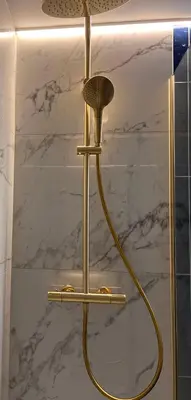 a shower with a yellow hose in a bathroom at Garden Street - Antiquity Blue in Lommel