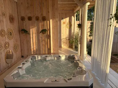 a bath tub in the middle of a room at Wellness B&B Essential by Cin in Zonhoven