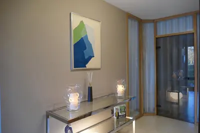 a living room with candles on a glass table at Aux Cosmos in Olne