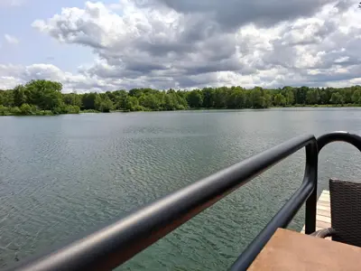 a view of a lake from a boat at Bosrijk gelegen vakantiehuis met optimale privacy! in Lanaken