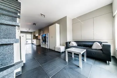 a living room with a couch and a table at Vakantiewoningen De Jud in Maasmechelen