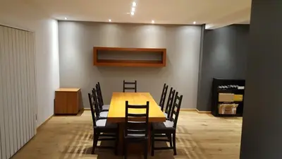 a dining room with a yellow table and chairs at Vakantiewoningen De Jud in Maasmechelen