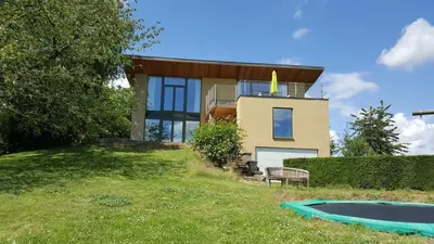 a house on top of a hill with a pool at Casa Loon in Borgloon