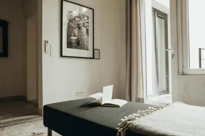 a bedroom with a bed with a book on it at Beauvoir, Parc de la Boverie by WelcHome in Liège