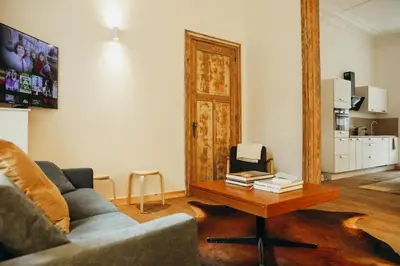 a living room with a couch and a coffee table at Beauvoir, Parc de la Boverie by WelcHome in Liège