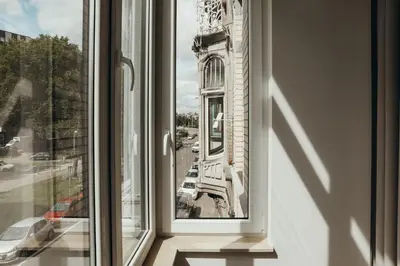 a window with a view of a building at Champagne, Parc de la Boverie by WelcHome in Liège