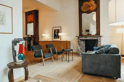 a living room with a couch and a fireplace at Champagne, Parc de la Boverie by WelcHome in Liège