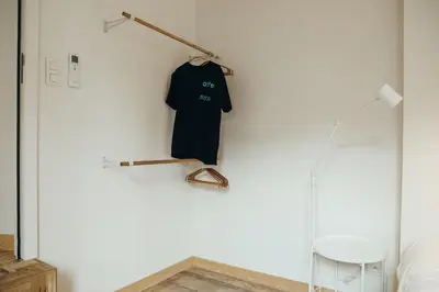 a black shirt hanging on a wall in a room at Champagne, Parc de la Boverie by WelcHome in Liège