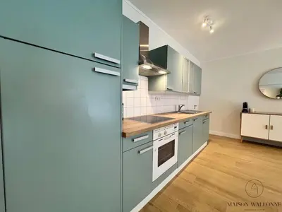 a kitchen with a blue refrigerator in a room at Open Design apartment in Liège