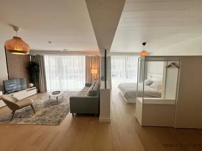 a large living room with a bed and a couch at Open Design apartment in Liège