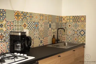 a kitchen with a coffee maker on a counter top at Le cocon chic - Hypercentre, Place du Marché in Liège