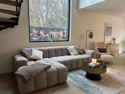 a living room with a couch and a table at Home Terboekt in Genk