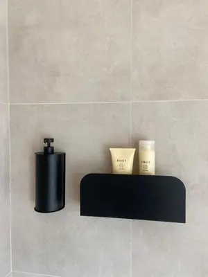 a black shelf with two candles on a wall at Les Tours de Rose - Characterful accommodation in Waremme in Waremme