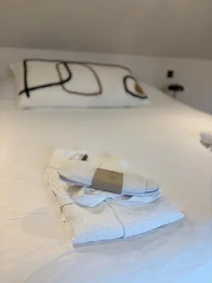a pair of glasses sitting on top of a bed at Les Tours de Rose - Characterful accommodation in Waremme in Waremme