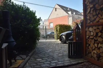 a driveway with a car parked next to a house at La Belle Échappée à Fléron in Fléron