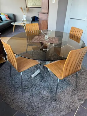 a glass table with two chairs and a glass table with a glass table at Bel appart - Tilff in Tilff