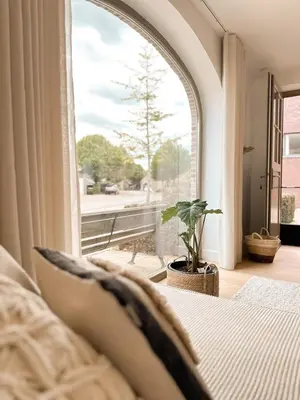 a bedroom with a bed and a large window at Ibiza LOFT MOLN in Kinrooi