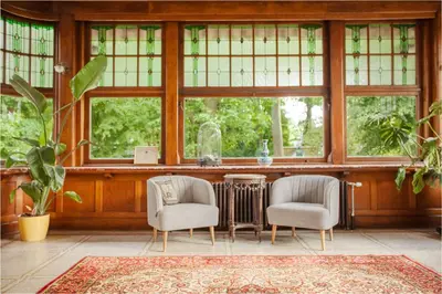 two chairs and a table in a room with windows at 12P 6B Renovated villa with jacuzzi at Genk in Genk