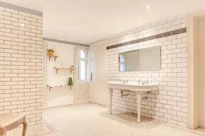 a white bathroom with a sink and a mirror at 12P 6B Renovated villa with jacuzzi at Genk in Genk