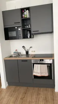 a kitchen with a sink and a counter top at Appartement dans rue calme in Liège